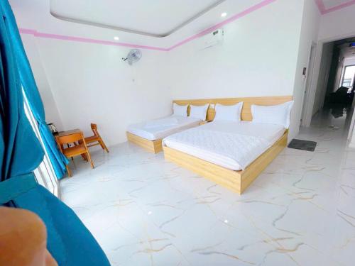 a bedroom with a bed and a couch in it at Khách sạn LyLy 3 in Thuan An