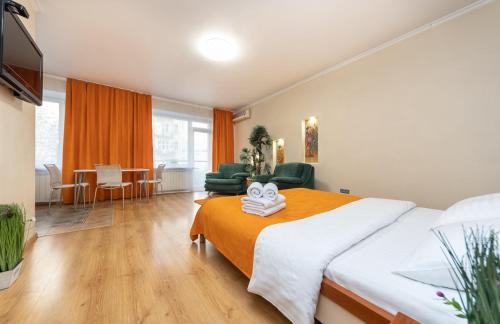 a bedroom with a large bed and a living room at Европейска площа in Kyiv