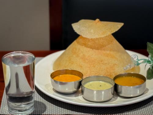 a plate of food on a table with a plate of food at HOTEL BLUEMOON in Tirunelveli