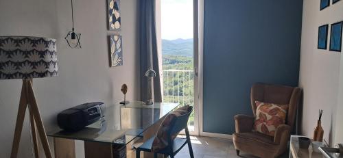 a living room with a glass table and a window at homeliday ACTIVE in Caldana