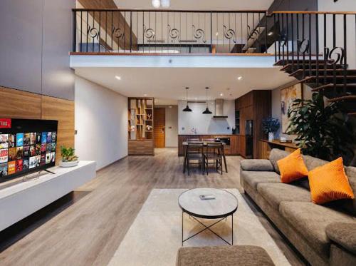 a living room with a couch and a table at Hi-Home Suites - Penstudio Westlake Hanoi in Hanoi