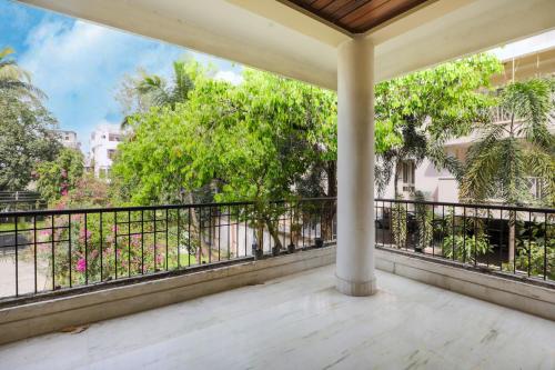an empty balcony with a railing and trees at Exotic Villa Homestay in Guwahati