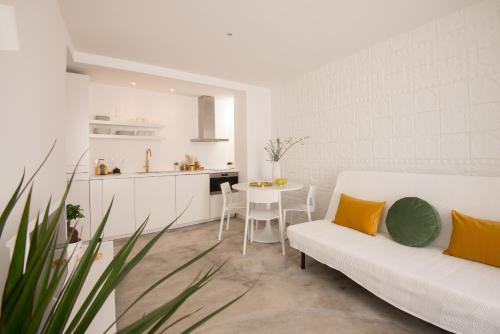 a living room with a white couch and a table at CASASUPERTUBOS - Apart 9 in Peniche City Center in Peniche