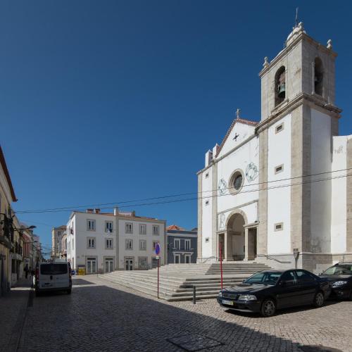 a church with cars parked in front of it at CASASUPERTUBOS - Apart 9 in Peniche City Center in Peniche