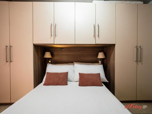a bedroom with white cabinets and a large bed at Marsaskala Duplex with Private Patio Near Promenade in Tas-Sienja