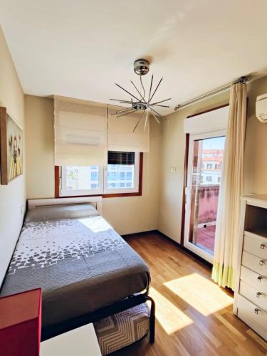 a bedroom with a large bed and a window at Modern duplex in downtown Cambados in Cambados