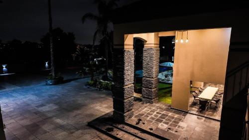 a patio at night with a table and chairs at Ondjo Yetu in Benoni
