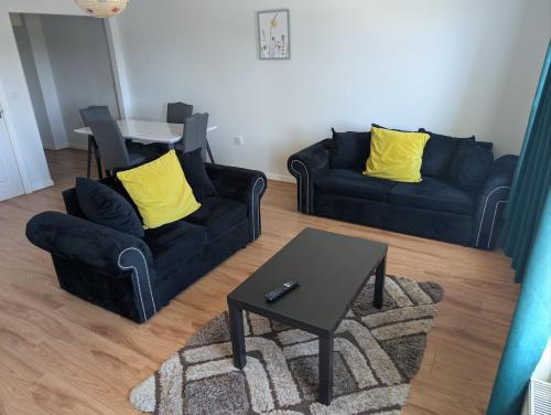 a living room with two couches and a table at Enbrook Luxury Lodge with Garage and Driveway in Shorncliffe Camp