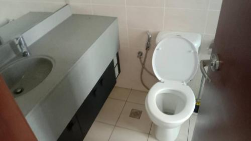 a bathroom with a white toilet and a sink at Peacehome 910 in Cyberjaya