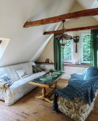 a living room with a couch and a table at Wsiowa Chata in Ścinawka Górna