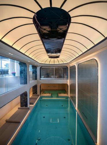 a swimming pool on a yacht with a ceiling at Excelsior Palace Portofino Coast in Rapallo
