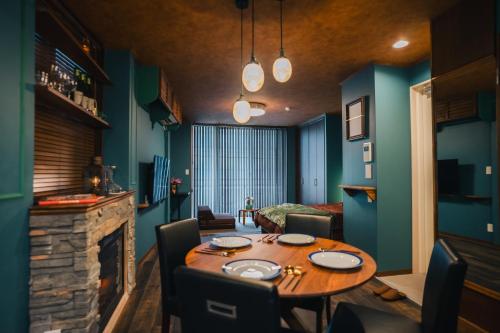 a dining room with a table and a fireplace at Villa Boushu KURAMAE in Tokyo