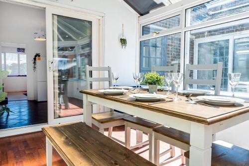a dining room with a table and chairs at Modern and Spacious 4 Bedroom Home in Ipswich in Ipswich
