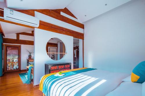 a bedroom with a bed and a mirror at Lijiang half yard hotel in Lijiang