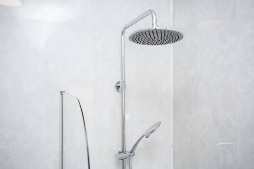 a shower with a shower head in a bathroom at Meldon Terrace Parking Wi-fi in Woodhorn
