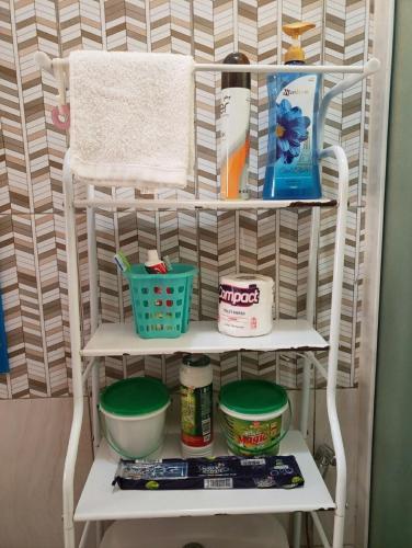 a white shelf with food and other items on it at The Urban Oasis Ntinda in Nalakonge