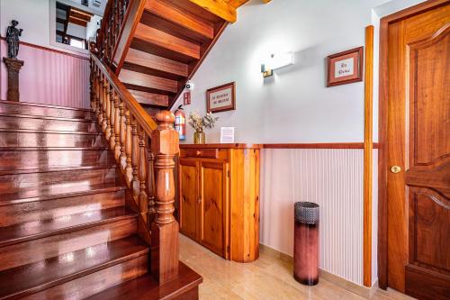 a wooden staircase in a home with wooden floors at Apartamentos El Rincón de Bustio in Bustio