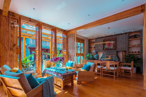 a living room filled with furniture and a table at Lijiang half yard hotel in Lijiang