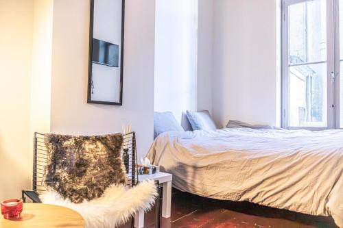 a bedroom with a bed and a table and a chair at Central Gent Stay 2 Bedrooms 4 Guests in Ghent