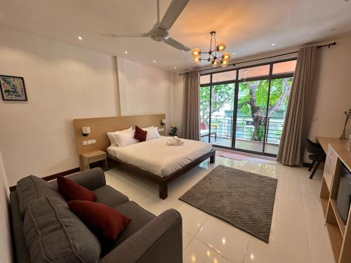 a living room with a bed and a couch at Island Getaway Villa - 5BR with Patio in Male City
