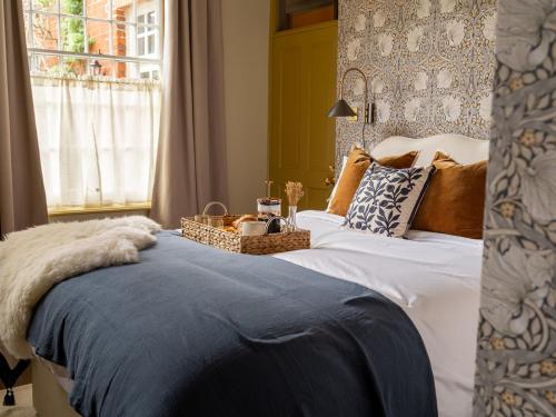 a bedroom with a bed with a basket on it at Chapman House 3 Bedroom Luxury Retreat in Norwich