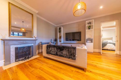 a living room with a fireplace and a tv at Room 1 - LEO Sky Guest House in Simondium