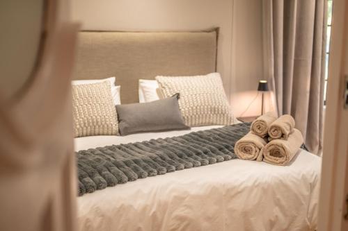 a bedroom with two beds with towels on them at Room 1 - LEO Sky Guest House in Simondium