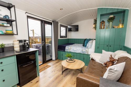 a living room with a couch and a bed at Willows Rest - 1 Bed Shepherds Hut - Pentlepoir in Saundersfoot