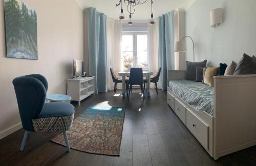 a bedroom with a bed and a table and chairs at AquaGate Jurmala in Jūrmala