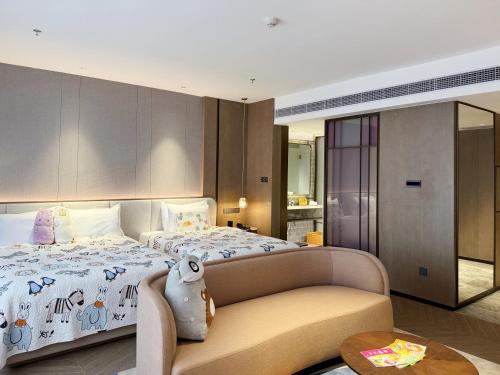 a bedroom with a large bed and a table at Baiyun Hotel Guangzhou in Guangzhou