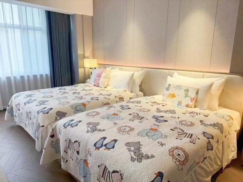 a bedroom with two beds with hello kitty blankets at Baiyun Hotel Guangzhou in Guangzhou