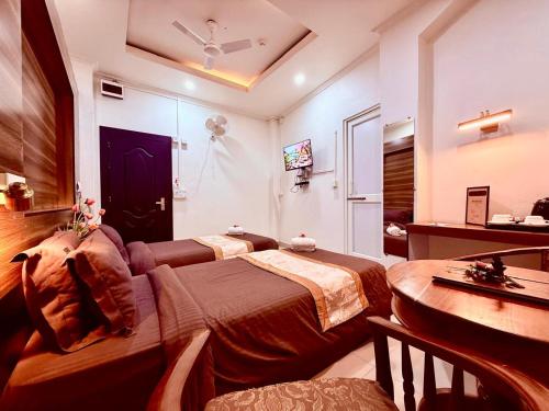 a bedroom with a bed and a table in a room at Rest Inn Hotel in Jāmb