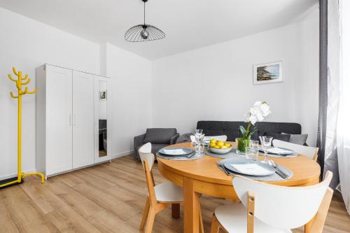 een eetkamer met een houten tafel en stoelen bij Piwna Apartament in Gdańsk