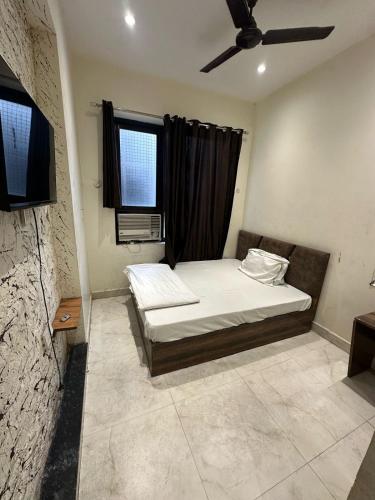 a bedroom with a bed and a window at Hotel PR in Amritsar
