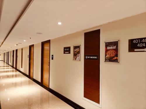 a hallway of a building with signs on the wall at MM Legacy - A Bergamont Hotel, Kanchipuram in Kanchipuram
