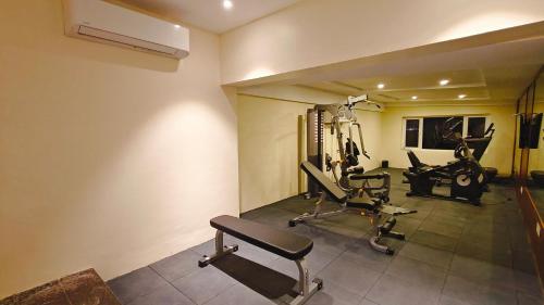 a gym with two treadmills and two exercise bikes at MM Legacy - A Bergamont Hotel, Kanchipuram in Kanchipuram