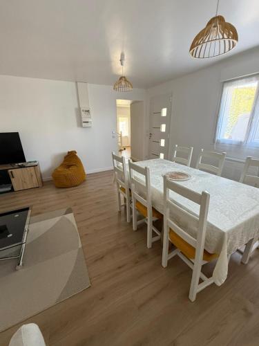 une salle à manger avec une table et des chaises blanches dans l'établissement Ty-Kokoon, à Saint-Quay-Portrieux