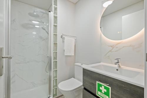 a bathroom with a shower and a toilet and a sink at Laurissilva Lodge, By OP in São Vicente
