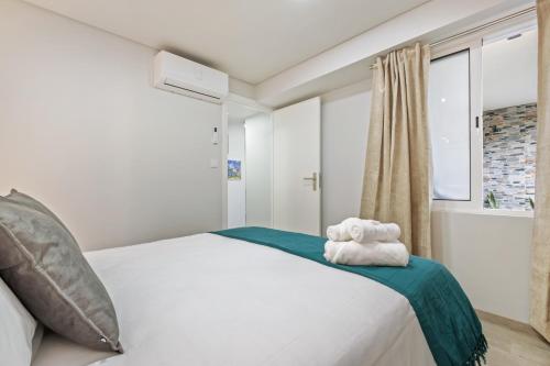 a bedroom with a bed with two towels on it at Laurissilva Lodge, By OP in São Vicente