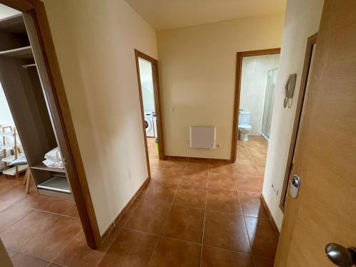 an empty room with a hallway with a toilet in it at CHARMING Playa O VICEDO in O Vicedo