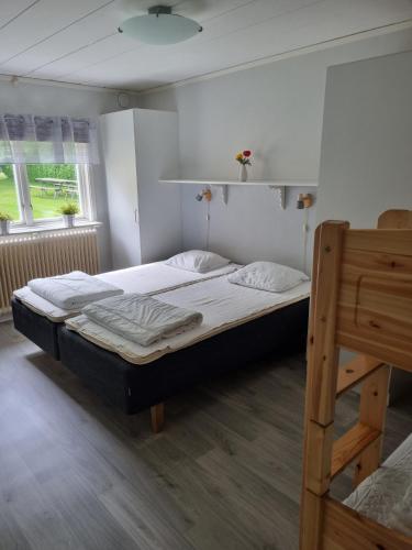 a bedroom with a large bed and a ladder at Nyckelbo Vandrarhem in Helsingborg