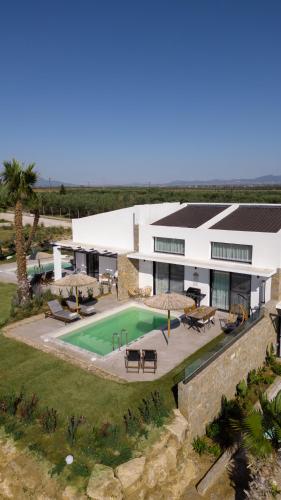 an aerial view of a house with a swimming pool at Flamingo Living Halkidiki - The Villas in Áyios Mámas