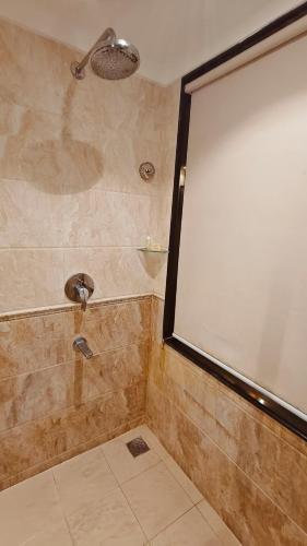a shower with a large screen in a bathroom at MM Legacy - A Bergamont Hotel, Kanchipuram in Kanchipuram