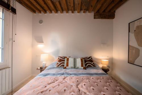 une chambre avec un grand lit avec deux lampes dans l'établissement Sainte Hélène - Lovely high class studio, à Lyon