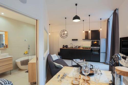 Il comprend une cuisine et un salon avec une table à manger. dans l'établissement Suite Garibaldi Cosy et Design, à Lyon