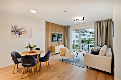 a living room with a couch and a table at Aparthotel Anchoria BlueApart in Mechelinki