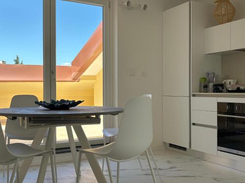 a kitchen with a table and chairs and a window at Golfo Ameno Apartment in Portovenere