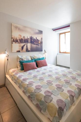 une chambre avec un grand lit dans une pièce dans l'établissement Le cocon des Monts d'Or, à Saint-Germain-au-Mont-dʼOr