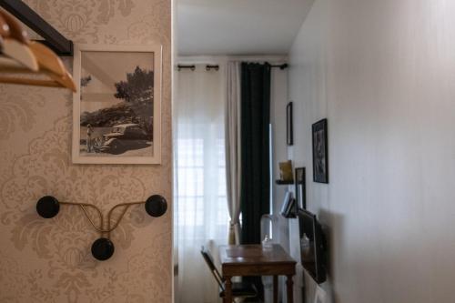 une chambre avec une table et une photo sur le mur dans l'établissement Le Gatsby Superbe cocon cosy proche place, à Lyon