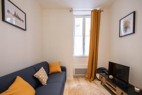 un salon avec un canapé bleu et une télévision dans l'établissement L'Opéra 9-Joli studio proche Opéra/Hôtel de Ville, à Lyon